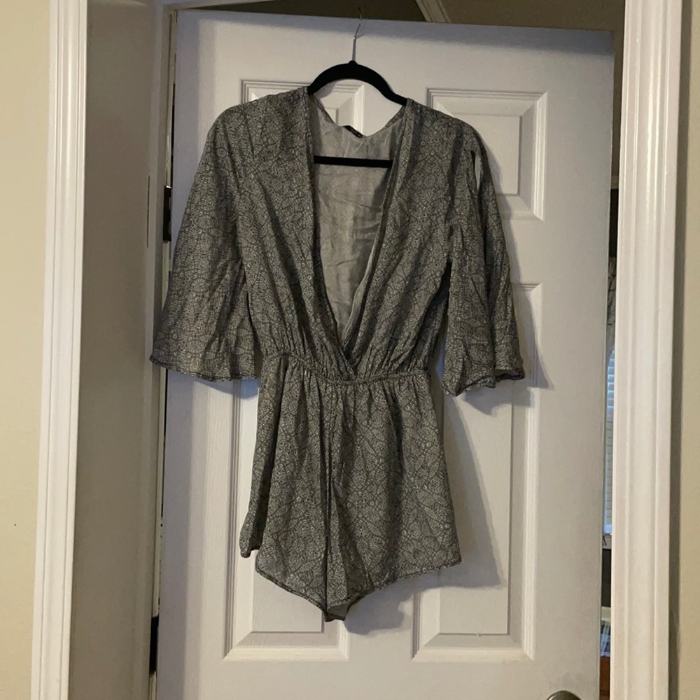 Dainty Hooligan Romper. Never worn with tags. Sleeves open to show shoulder